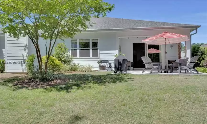 Rear view of property featuring a patio area and a yard