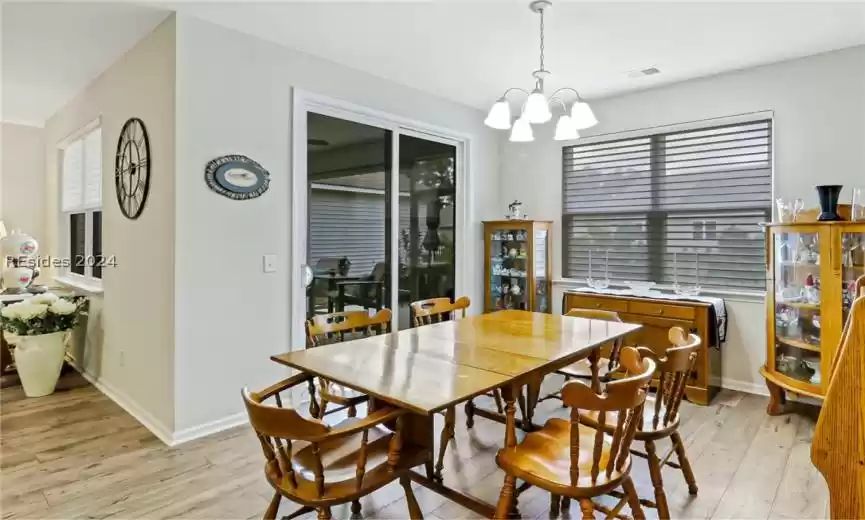 Dining room with a chandelier and light hardwood / wood-style floors