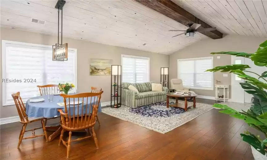 Living room with hardwood / wood-style flooring, wood ceiling, and lofted ceiling with beams