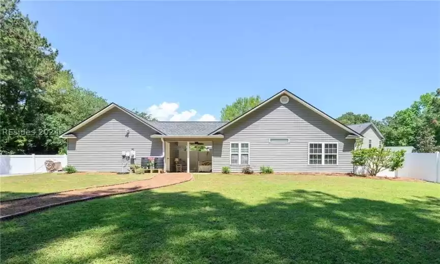 Rear view of property featuring large yard